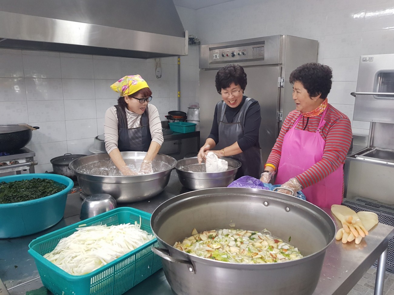 주방에서 반죽을 치대는 자원봉사자 모습